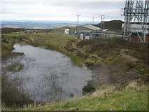 SO5986 : Pond and radio station on the top of Brown Clee by Row17