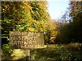 Sign by roadside for clearing in the wood