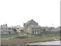 Capel Seion and the former manse from the opposite bank of Afon Ffraw