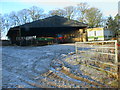 Straw bales under cover in frozen farmyard