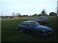 Out to pasture; veteran cars parked in field