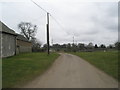 Road heading south-west past St Peter ad Vincula, Colemore