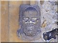 TL7924 : Stone Face at Entrance to All Saints Church by PAUL FARMER
