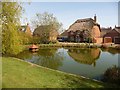 Throop: thatched cottage and pond