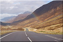 NH0659 : Rainbow over the A832 in Glen Docherty by Roger Davies