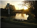 Duck pond and bus stop at Polgigga