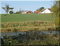 Pond and field rising towards Wetherden Hall Farm