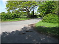 Sharp bend in road at junction with footpath