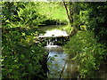 Small waterfall next to cottage