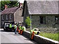 Ten people taking it in turns to look over a wall