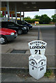 Mile marker on garage forecourt, Ipswich