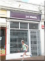 Jogger passing "just music" in Stoke Road