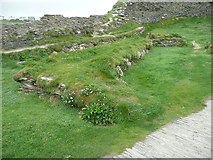 SX0588 : Foundations within the outer ward of Tintagel Castle by Humphrey Bolton