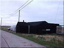 TR0917 : Black rubber cottage, Dungeness by Chris Whippet