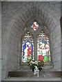 Floral display beneath a stained glass window at St Giles, Ludford