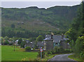 Picturesque Kintyre village with wooded hills beyond