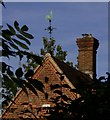 Weather vane and pigeonholes seen from bridleway