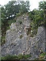 Climber abseiling down Aldery Cliff