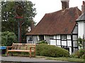 Old timber-framed house and village sign in Robertsbridge