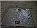Inspection cover bearing the name G Scamp, Builder, Ilfracombe