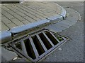 Drain cover on the corner of Fore Street & Mill Head bearing the numbers 8497