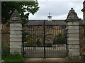 Iron gates to restored house in Sandford St. Mary