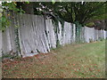 Old oak fencing and gate bordering houses at Poynings