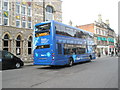 Blue bus passing The Guildhall