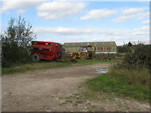 TQ1814 : Farm machinery at New Wharf Farm by Dave Spicer