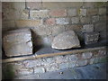 NZ0461 : Bywell St. Peter - mediaeval stones in the porch by Mike Quinn