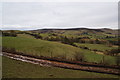 Muddy farm track leading down off the moors