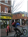 Exuberant cyclist in the High Street