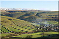 Smoke drifting over Kettlewell and snow on Great Whernside