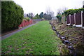 A path and a stream cut through a new housing development