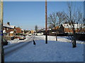 Approaching the junction of  a snowy Linkenholt Way and Colbury Grove