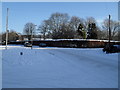 Approaching the junction of a snowy High Lawn Way and Broadmere Avenue