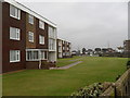 Looking across a grassed area in Sea Road