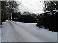 Approaching the junction of a snowy Wade Court Road and North Close