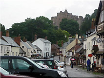 SS9943 : Dunster high street and castle from the Yarn Market by Phil Champion