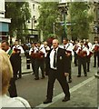 An accordion band and a minder in the AOH parade along Hill Street