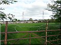 Gate, field, pylons, houses