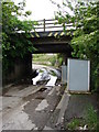 SJ1283 : Rutted road beneath the railway bridge by Ian Paterson