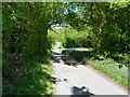 Steeply downhill on the lane near Smethcott Common