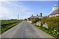 Looking southwest along road in Lady Village, Sanday