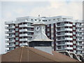 Flats on Russell-Cotes Road and the clock on top of the shops, viewed from the beach