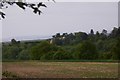 View of Idsworth House across field and woodland