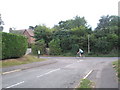 Cyclist passing the junction of Pulens Lane and Pulens Crescent