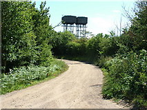 TM3652 : Dirt track past water towers, Bentwaters by John Goldsmith