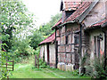 Public footpath past old barns at Church Farm, Hethel