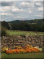 Wall and flower bed near the entrance to Rails House Farm with Crosspool on the horizon